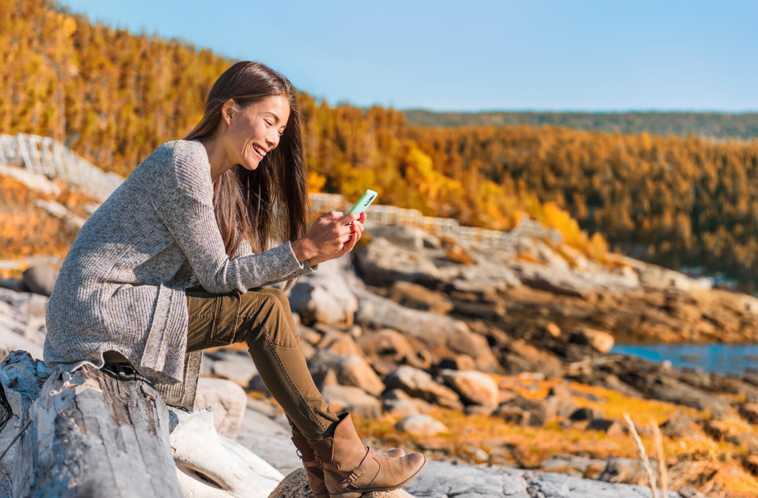 a person using phone in the mountains