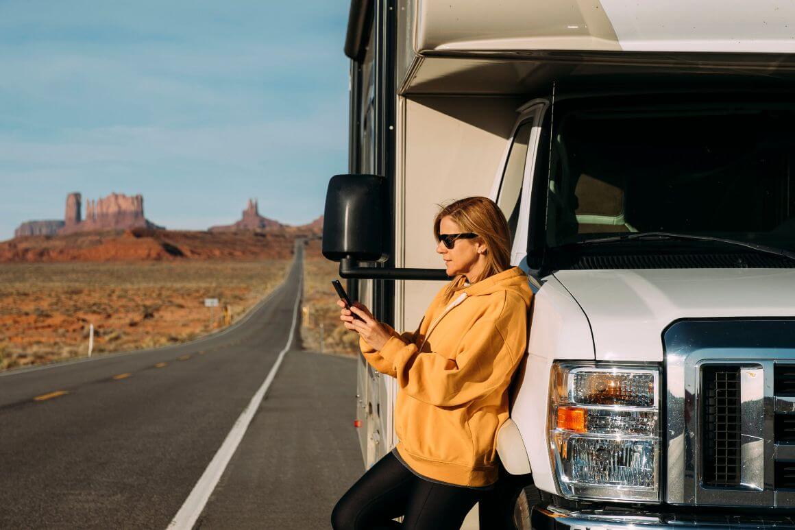 woman leaning on car at a deserted road