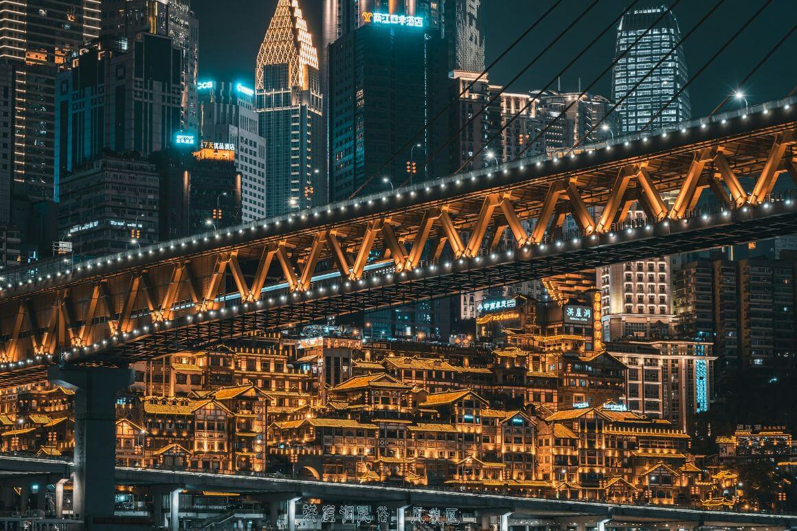 big buildings and bridge in bright city night light