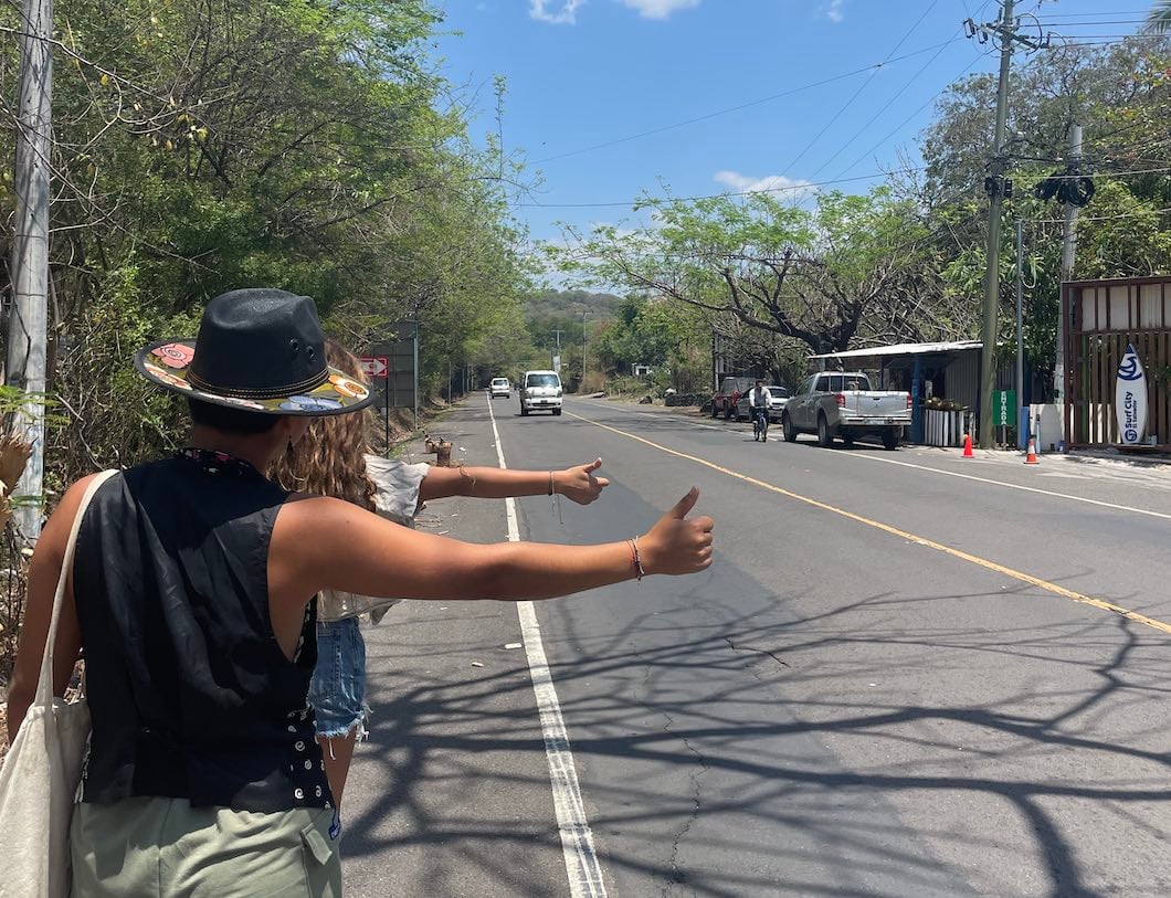 People flagging down a ride whilst hitch hiking in El Salvador, Central America