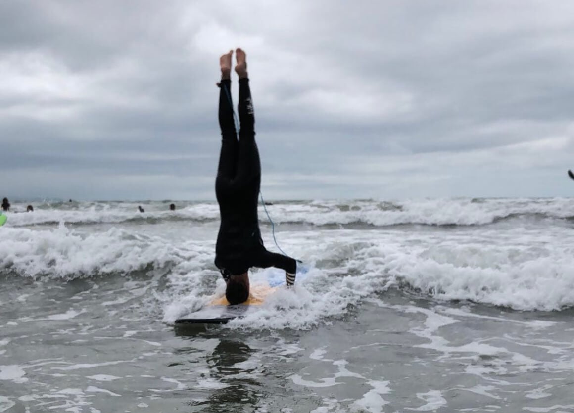 headstand on a surf board