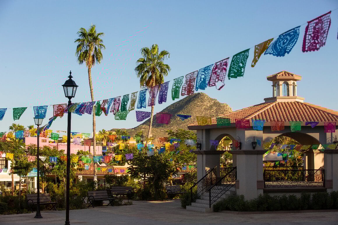 A gasebo surrounded by colorful paper decorations in the heart of downtown Cabo San Lucas