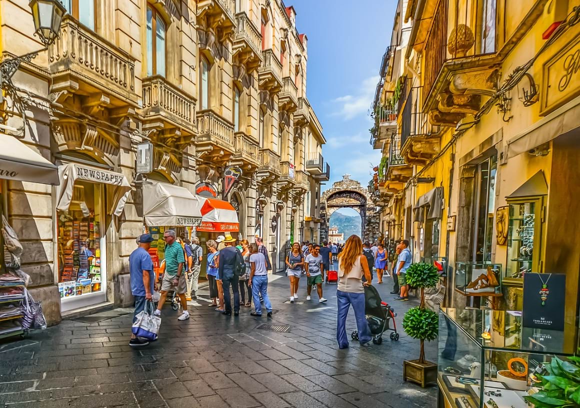 People strolling down a narrow street at Taormina old city  