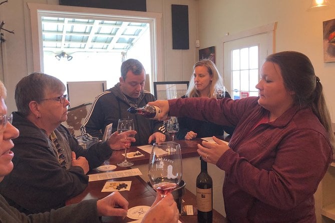 A women serving wine to a group of people in Texas Hill Country vineyards Fredericksburg