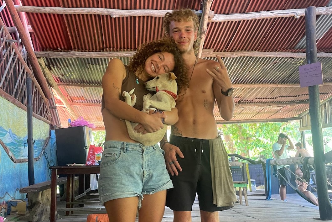 Guy and girl posing for photo in Costa Rican hostel.