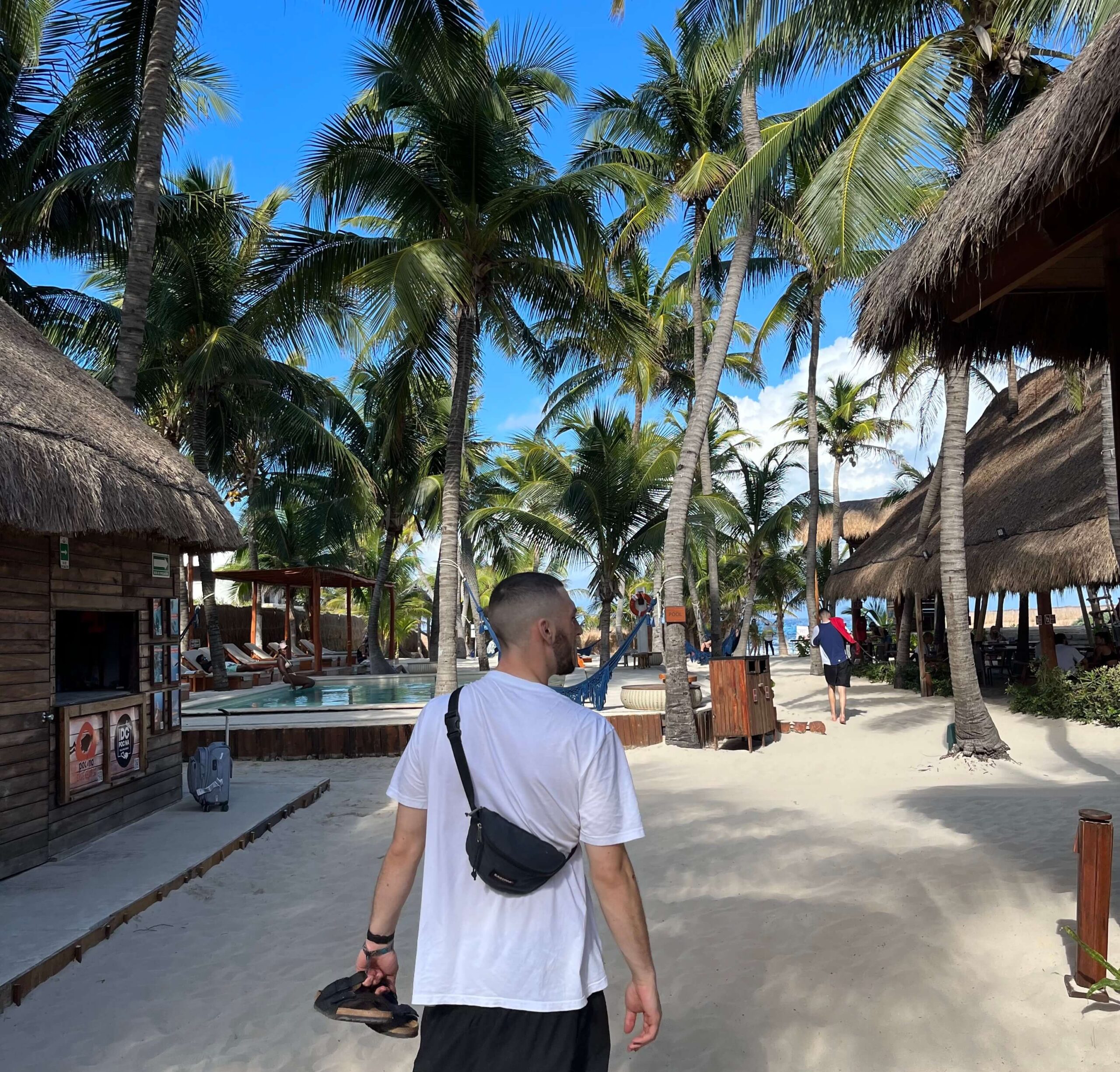 Joe casually strolling through Isla Mujeres, Mexico, with a cross-shoulder fanny pack.