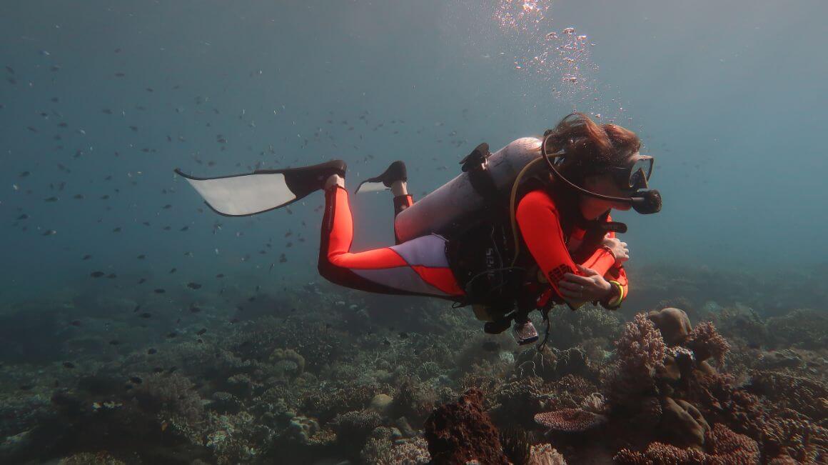 A girl scuba diving in Komodo, Thailand