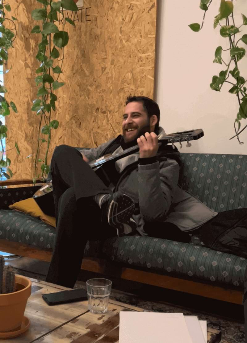 Dude playing guitar in hostel