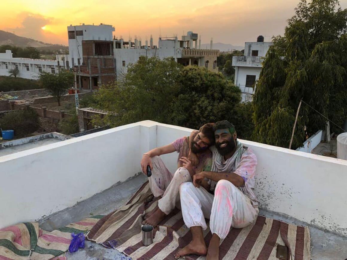 sharing-the-luv two guys sitting on the roof of a hostel in india