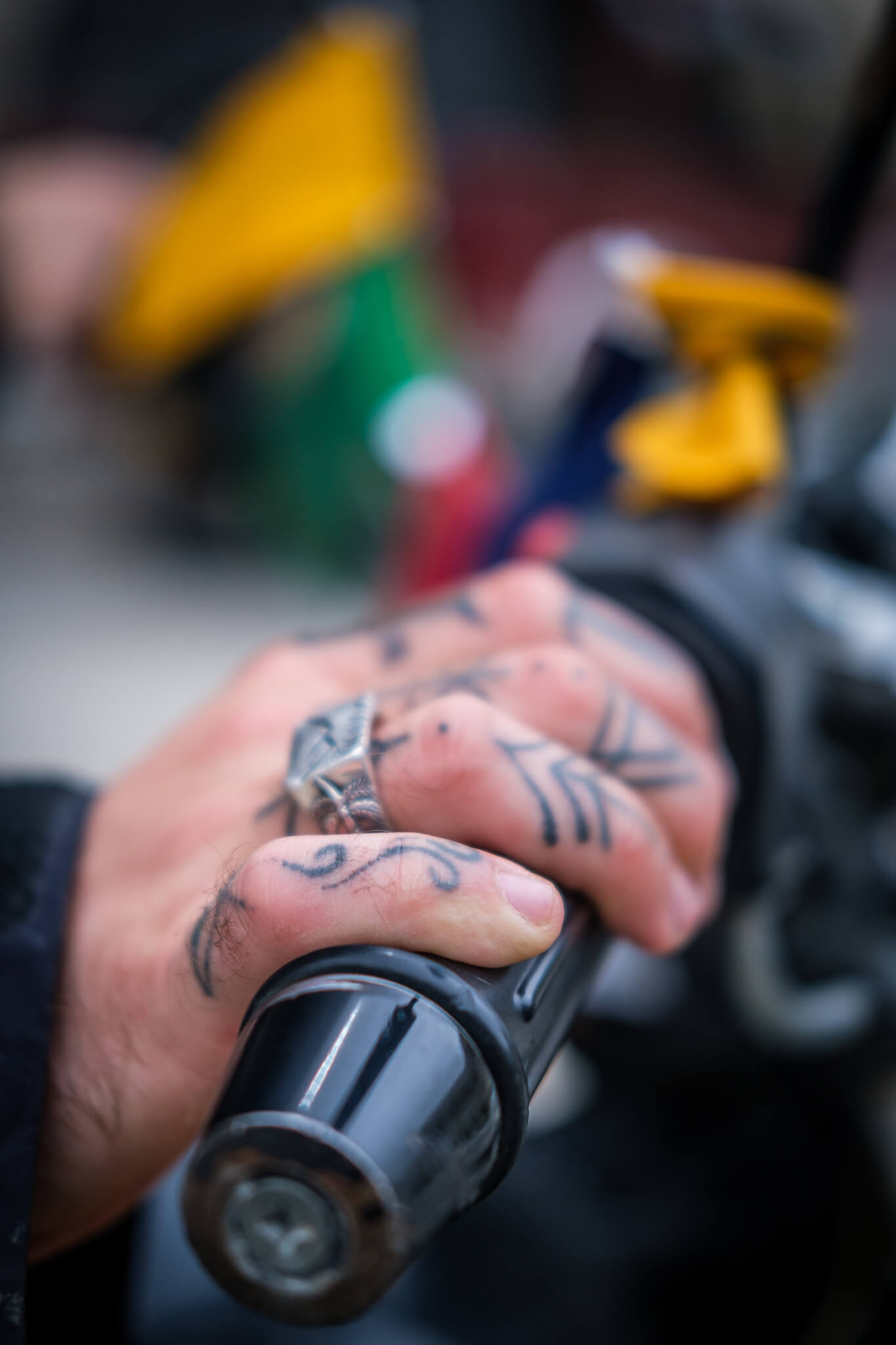 will's tattoed fingers gripping the handlebar of a motorbike in pakistan