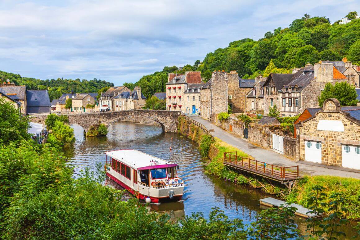 A boat crossing la Rance river in Dinan Brittany, France