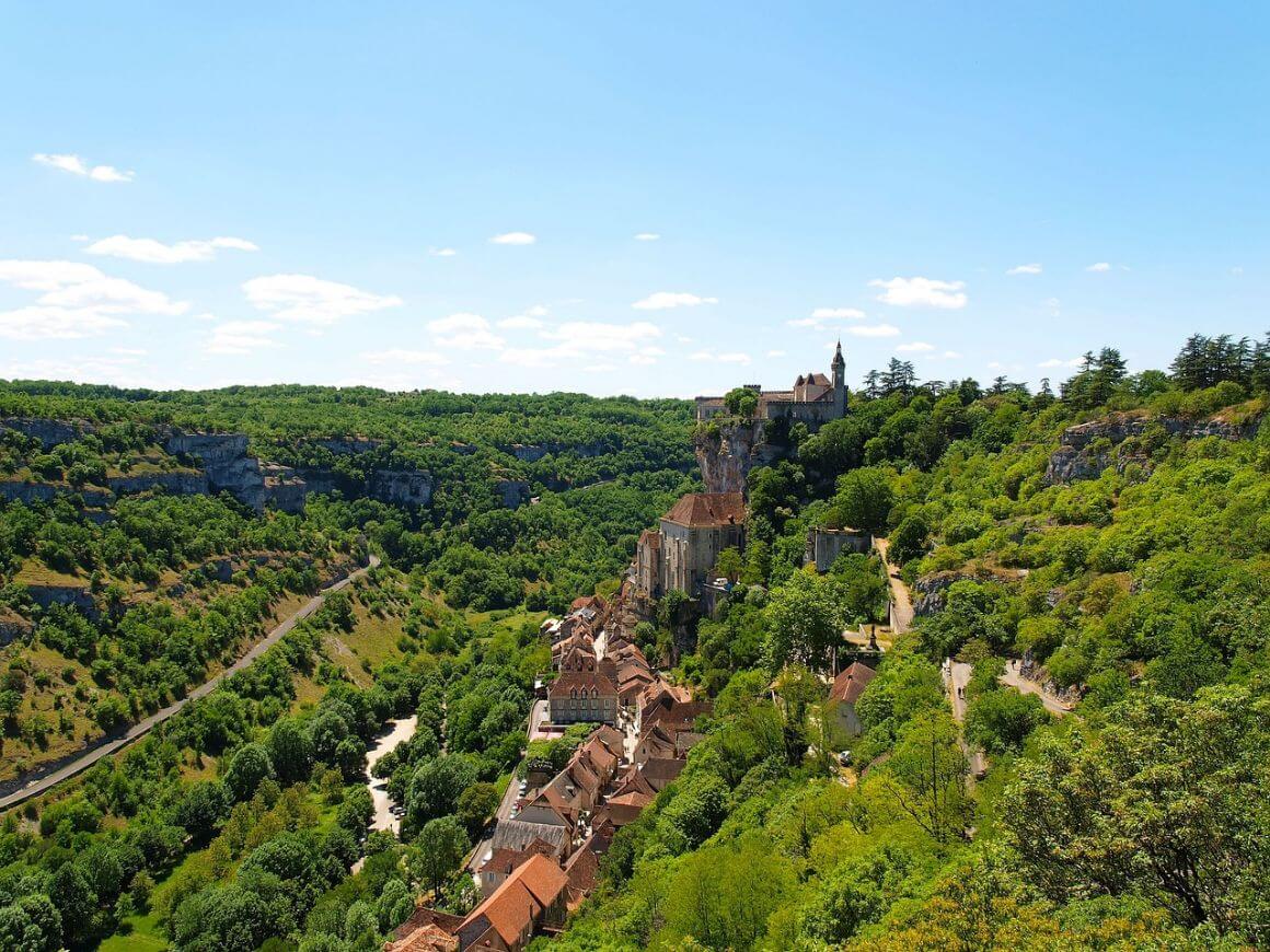 Buildings lined in the hillside commune of Rocamadour Dordogne, surrounded by lush valleys