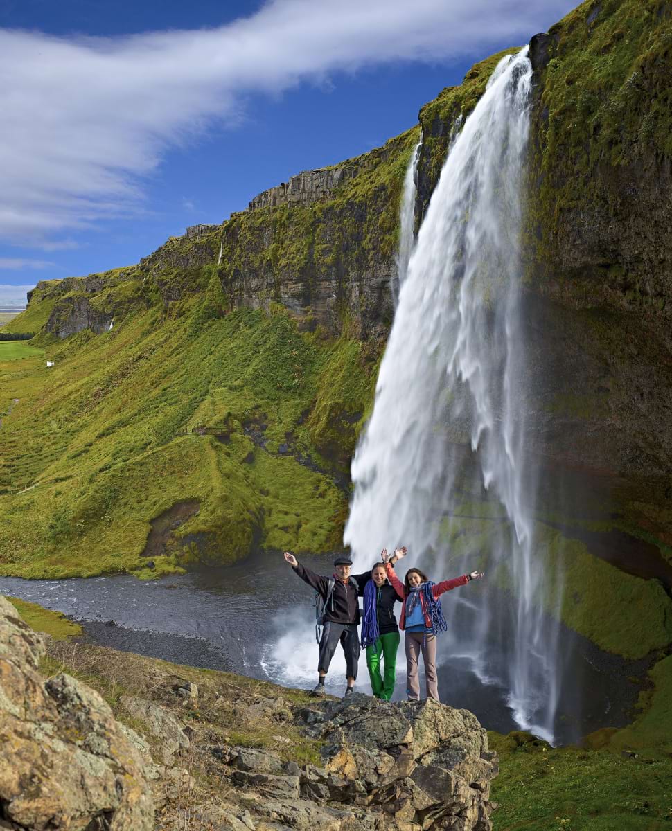 Group of climbers on the waterfall background