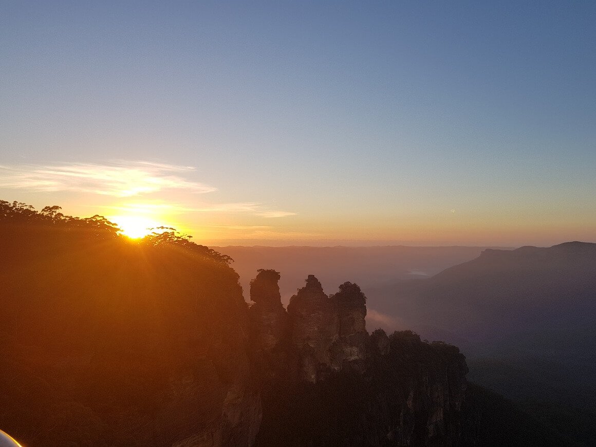 Sunrise on a misty morning at the three sisters rock formation in the Blue Mountains, near Sydney, Australia