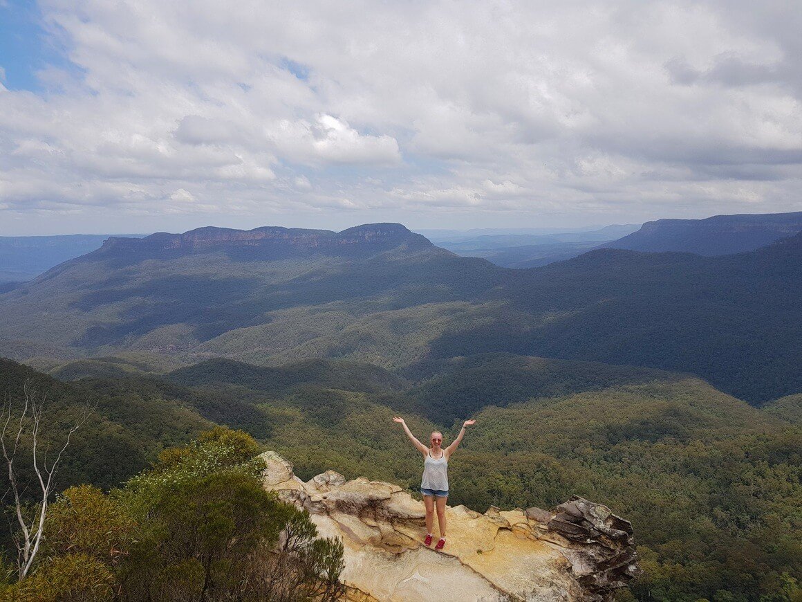 laura stood on a rock in front of a mountain backdrop