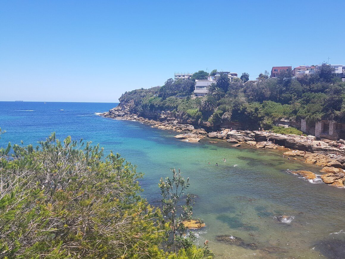 A bay on the coogee beach walk with blue skies and blue seas 