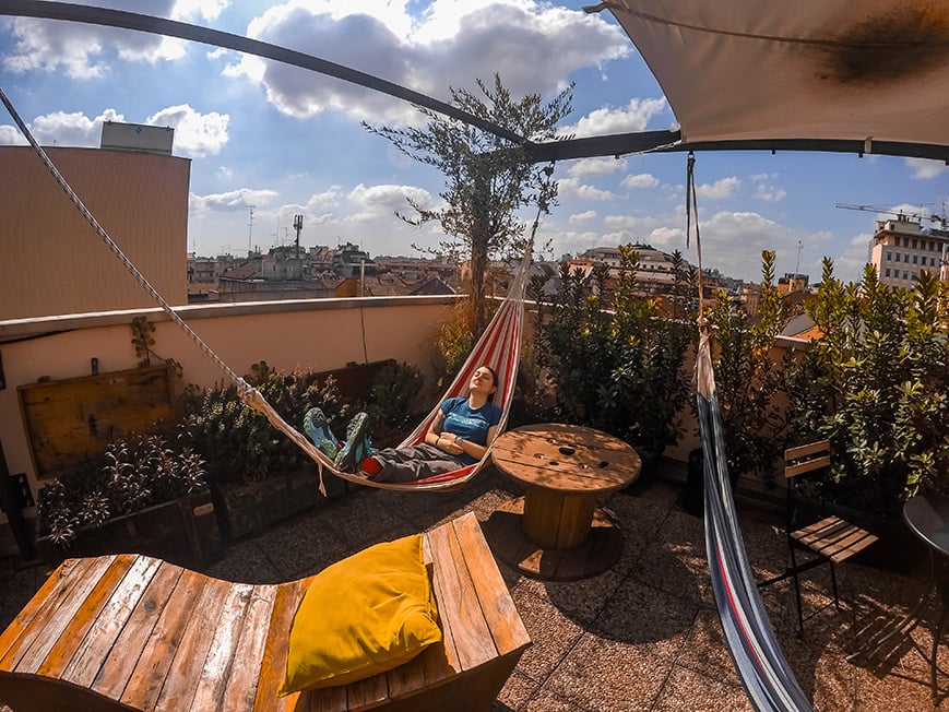 A person chilling out on a hammock at a hostel