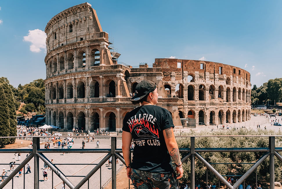A person looks out over the colosseum in Rome