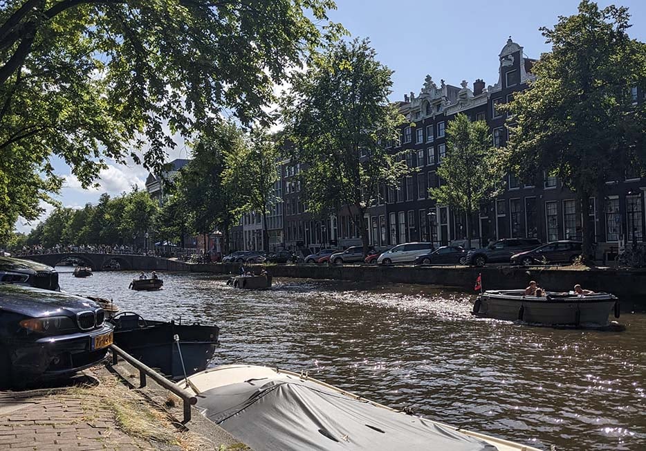 Looking over the canal to a row of traditional houses in Amsterdam