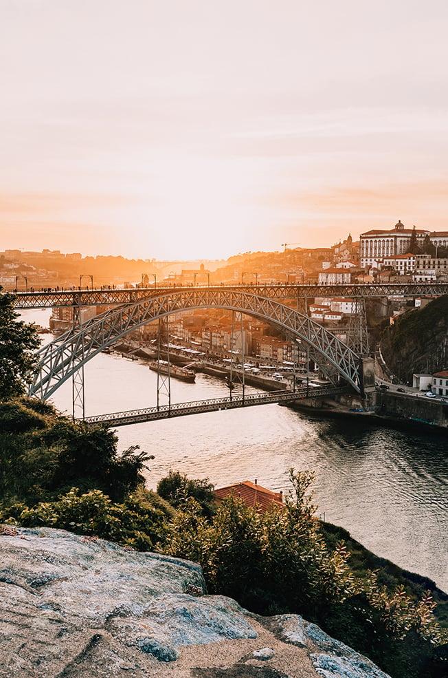 Looking over the river and bridge in Porto, Portugal at sunset