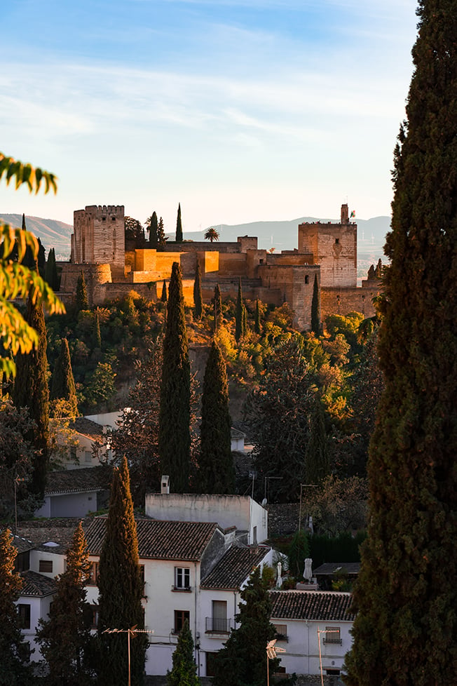 The sun setting behind Alhambra in Granada, Spain