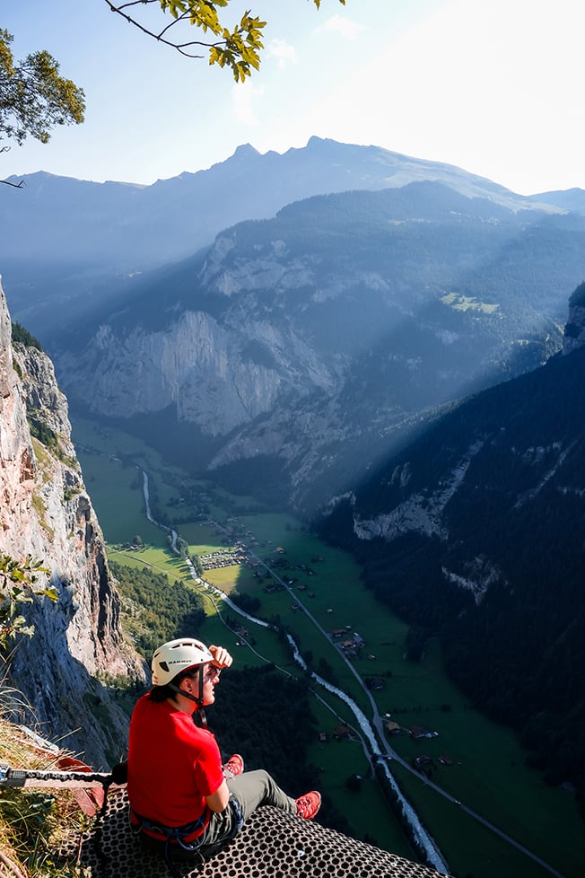 A person looking out over Lauterbrunnen valley in Switzerland.