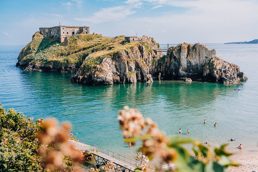 A rocky island off the beach at Tenby in Wales.