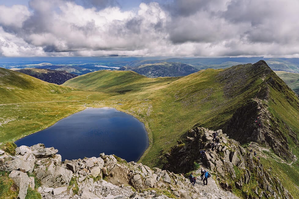 Looking down on the striding edge ridge and red tarn from the summit of Helvellyn, Lake District.