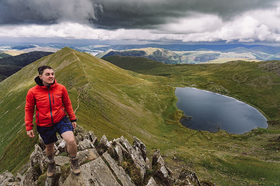 A person on Striding edge on Helvellyn in the Lake District in England.