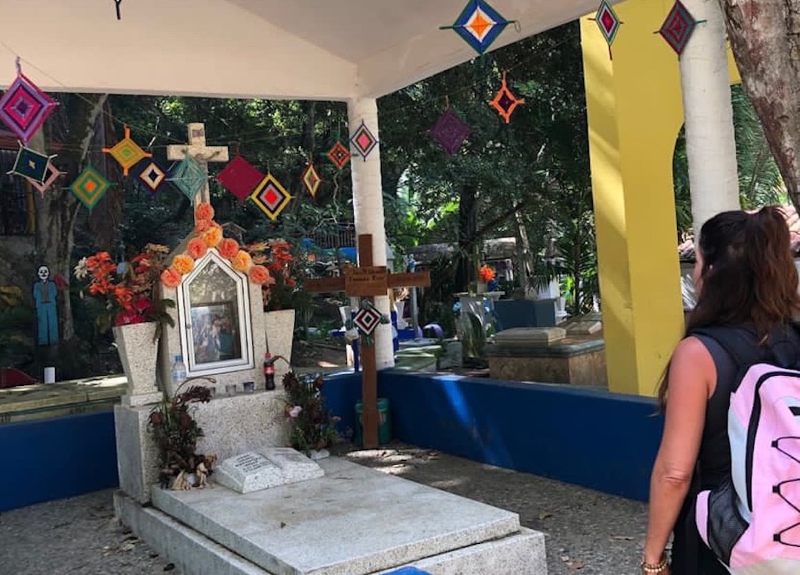 Girl looks over a wonderfully decorated graveyard on her way to the beach in Sayulita, Mexico.
