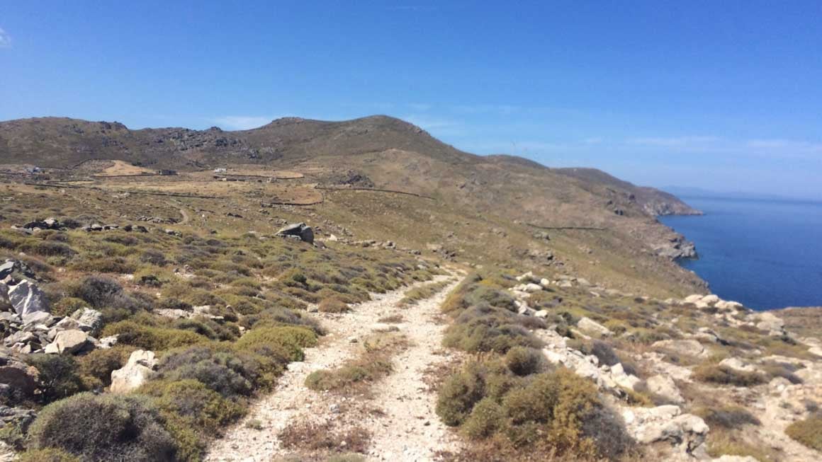 Landscape photo of a dirt road leading towards the sea