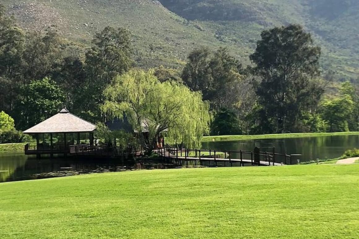 a small walk way and round building on top of a river in Cape Winelands Vineyard Tour (Elgin)