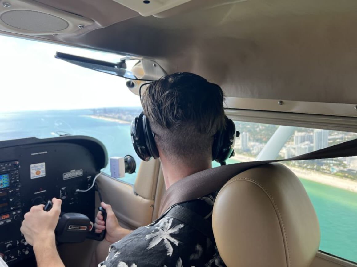 Man piloting an aircraft while taking in the scenic views.