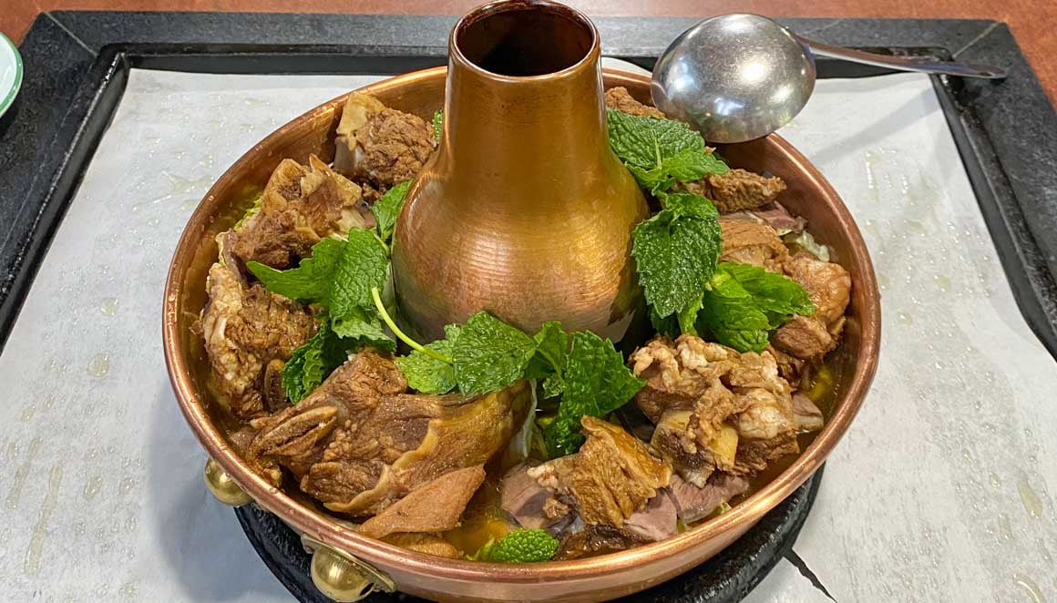 A traditional copper pot with yak meat hotpot inside