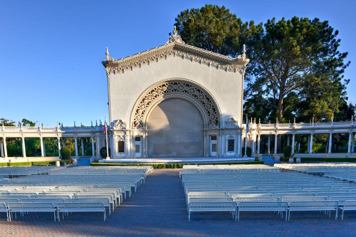 white benches in front of a stage in Spreckels Organ Pavilion, in Balboa Park, San Diago
