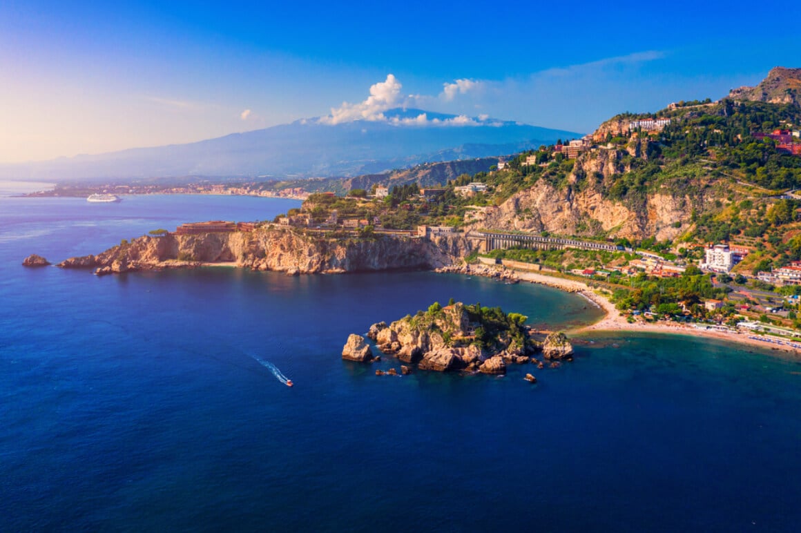 an aerial view of Sicily Italy with mountains in the background