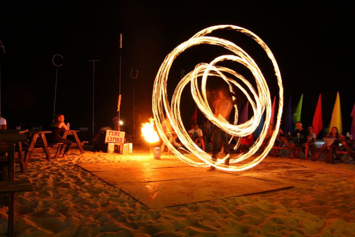 A man performing a fire show during a Full moon party in Koh Phangan, Thailand 