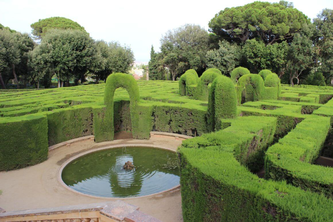 A lush garden and flower-fringed paths surrounding a fountain in Parc del Laberint d’Horta, Barcelona