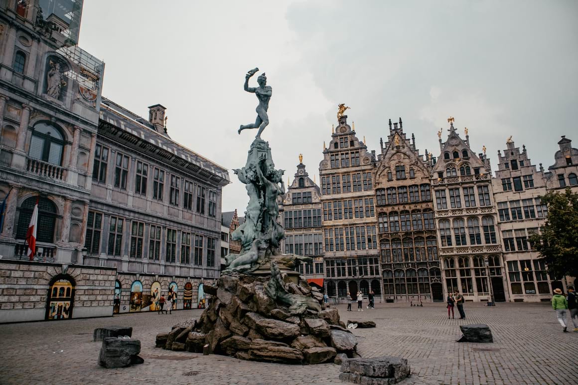 Antwerp City Hall, Belgium with a statue of Brabo standing on the Silvius Brabo Fountain.