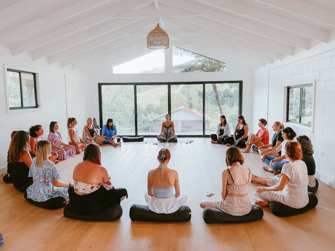 group of women sitting in a circle meditation in Press Pause Womens Retreat
