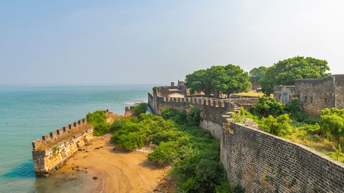 old brick fort on India's Diu island right along the turquoise Arabian Sea
