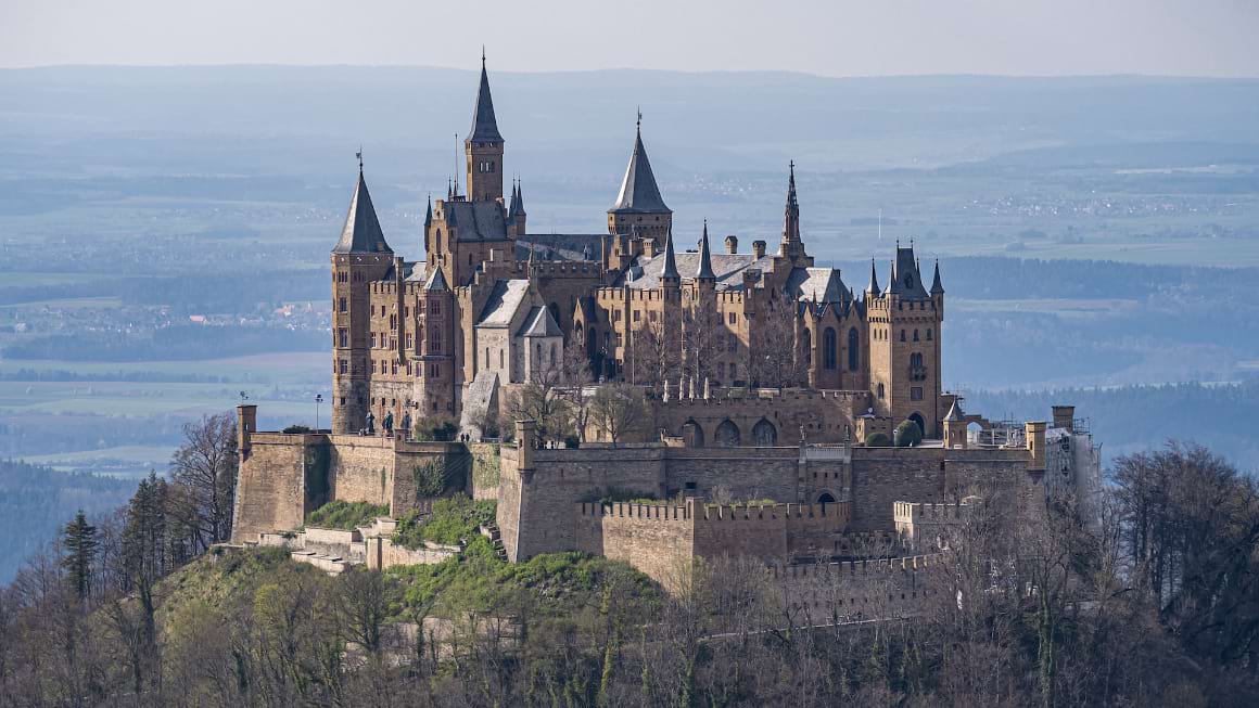 A picturesque view of Hohenzollern Castle rising on top of a hill 