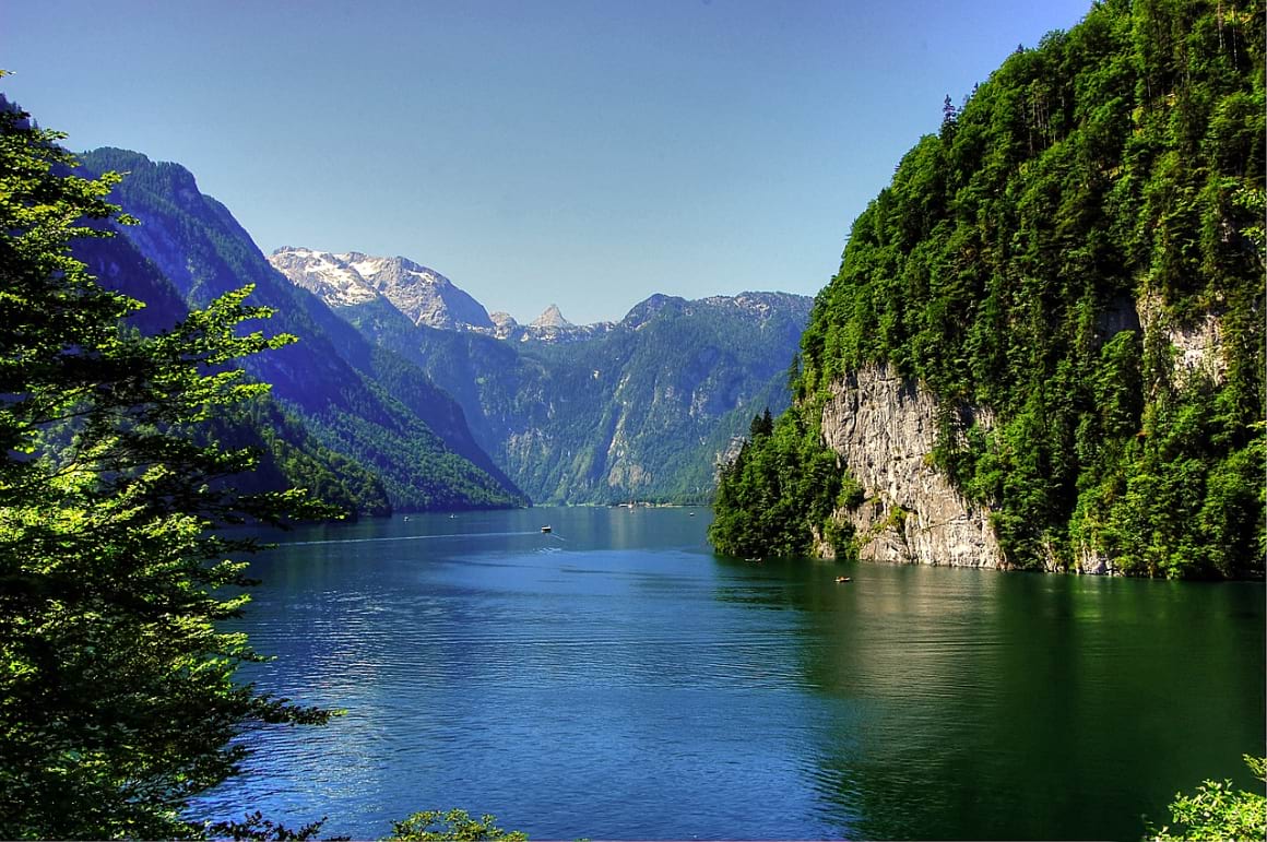 Lake Konigssee surrounded by mountains and lush greenery in Germany