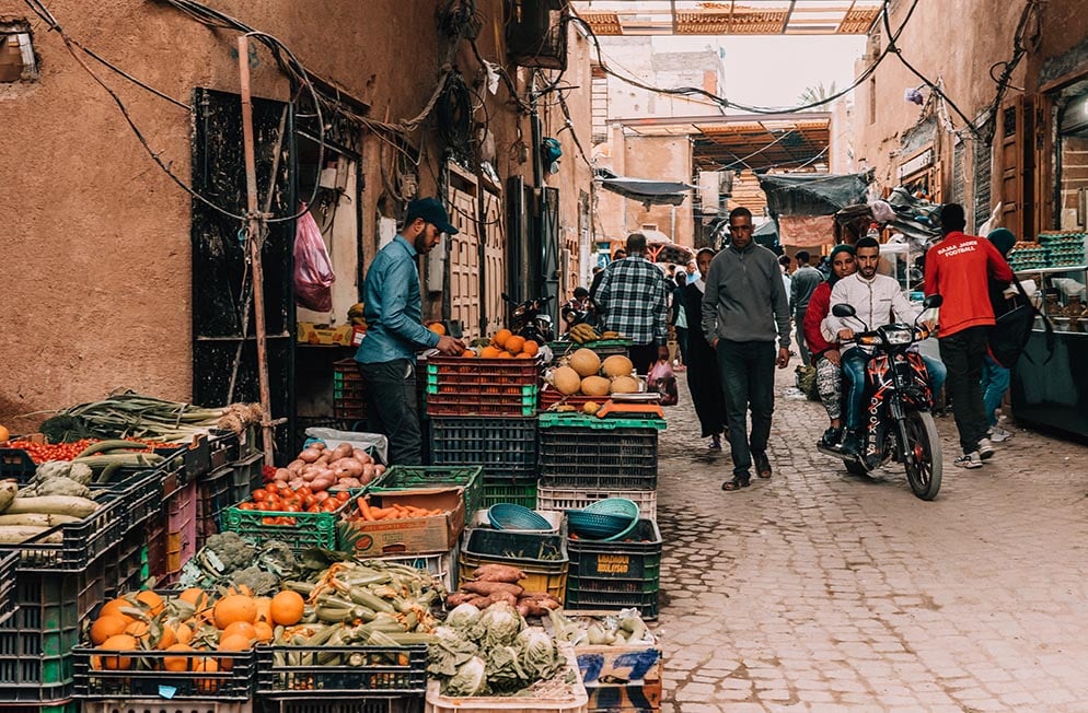A fruit and veg stall in a busy medina street, Morocco.