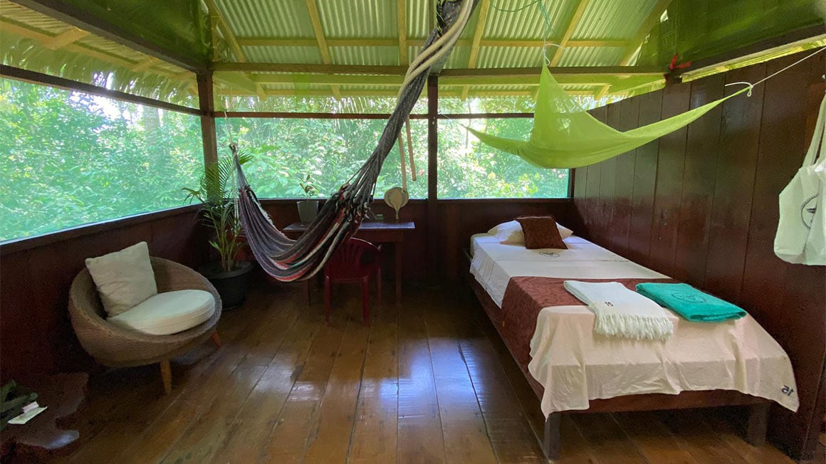 Accommodation in South America in the Amazon jungle with hammock, single bed and a mosquito net.