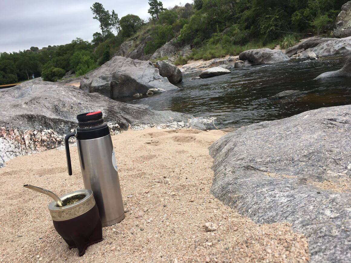 Thermo flask and mate by the side of the river