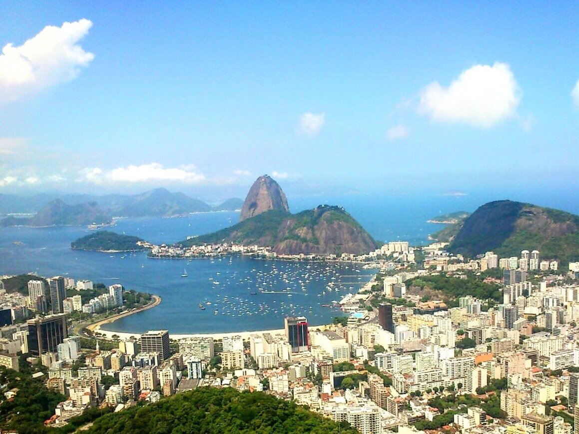 Rio de Janeiro view from top. Buildings and coastline beach near city.