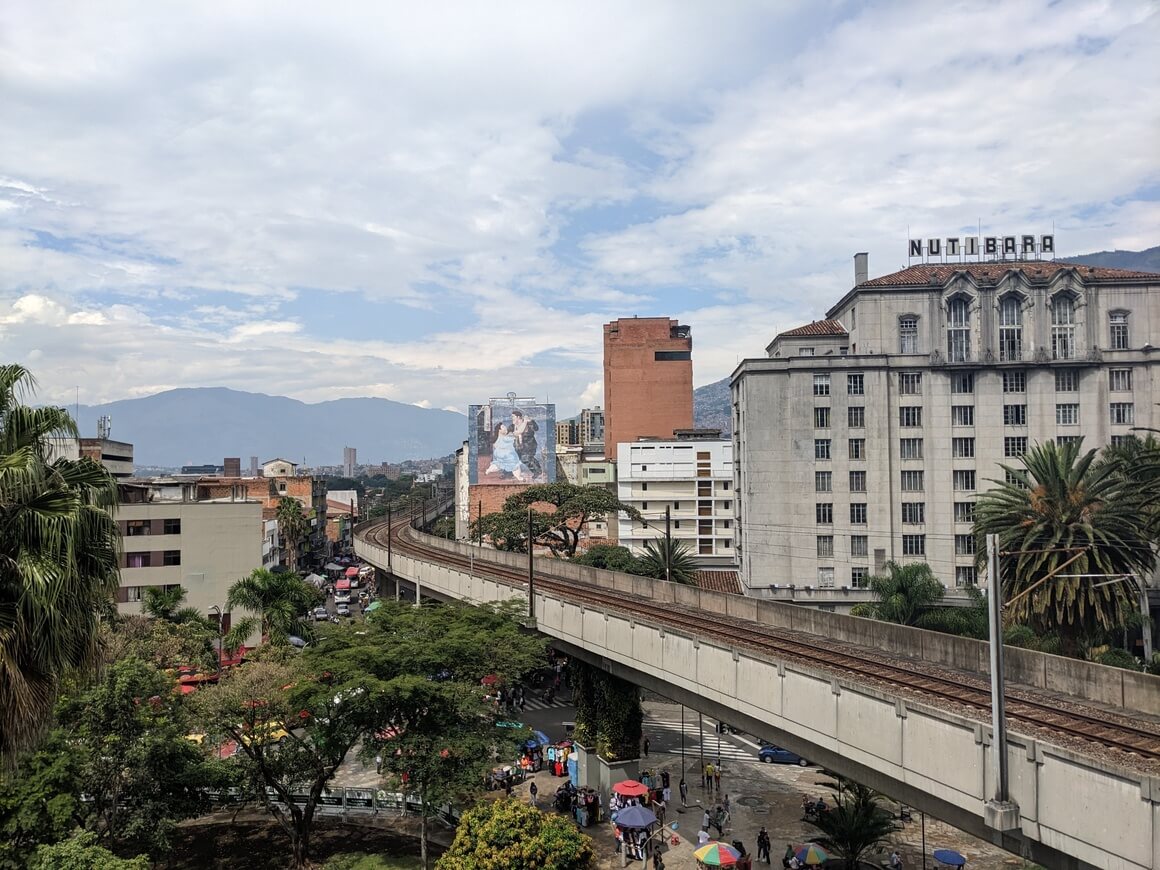 Metro line in Medellin with art from Fernando Botero on a building