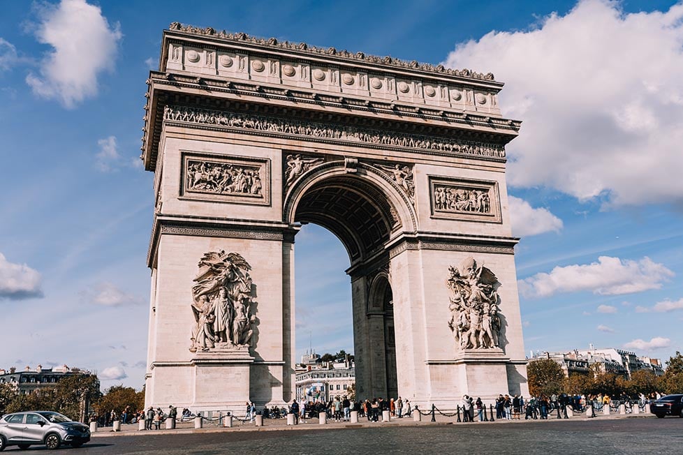 Looking across as the Arc De Triomphe with a sunny sky behind