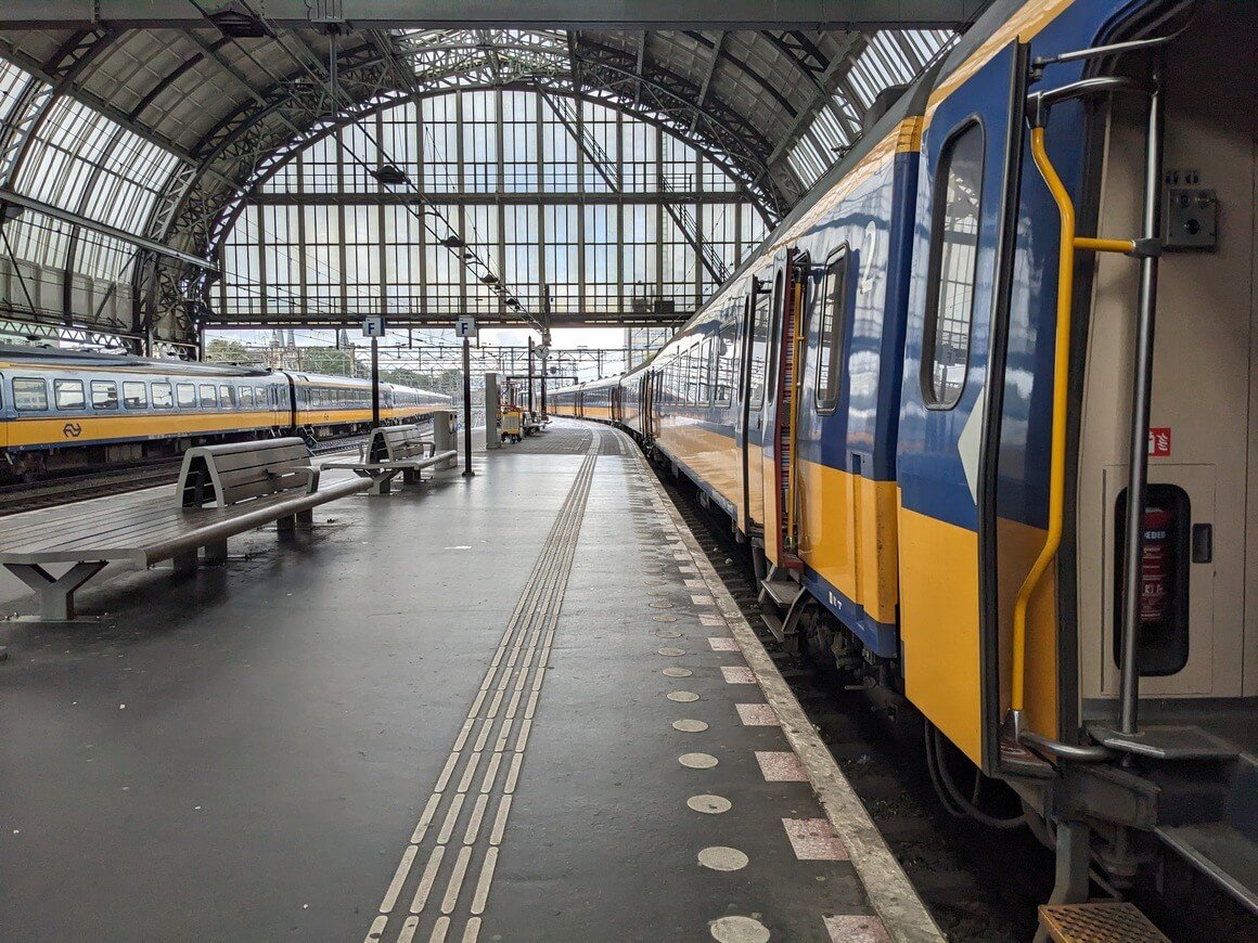 train waiting on the platform with the doors open in Amsterdam station.